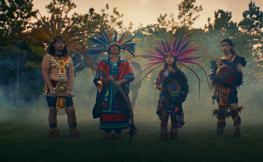 Rain Flowa (second from left) stands alongside her family in traditional garb.