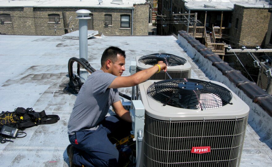 Eric Rebolledo, a repairman for AllTemp heating and air conditioning in Chicago, works on an air-conditioning unit on the roof of an apartment building. "I don't remember it being this hot for at least 10 years that I can recall," he says. "This is unusual, man, so it's gonna create some havoc with the air-conditioning  systems."