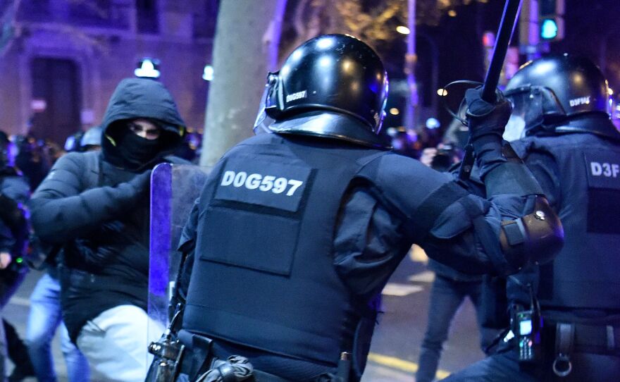 Protesters clash with Mossos d'Esquadra, the Catalan police force, following a demonstration Saturday in Barcelona against the imprisonment of Spanish rapper Pablo Hasel.