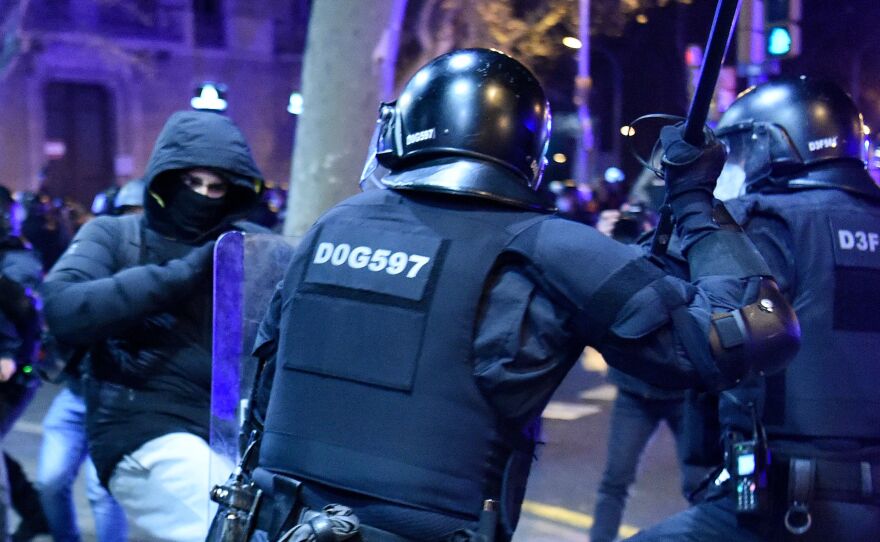 Protesters clash with Mossos d'Esquadra, the Catalan police force, following a demonstration Saturday in Barcelona against the imprisonment of Spanish rapper Pablo Hasel.