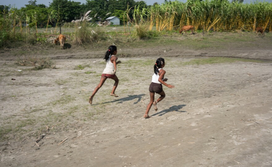 Children play on the banks of the Brahmaputra River.