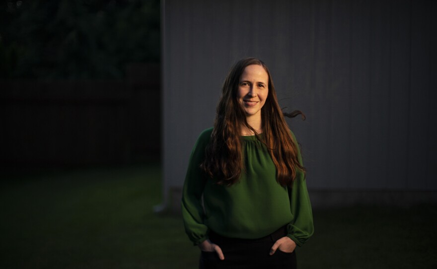 Cati Bennett, a chaplain resident in the VA health care system in Portland, Ore., stands in her backyard in Vancouver, Wash., on June 23. She became a hospital chaplain during the pandemic.