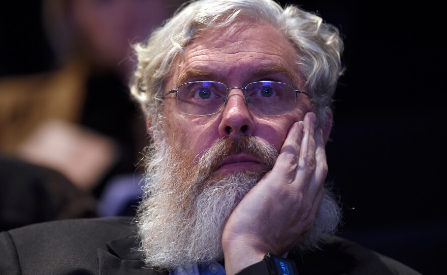Harvard Medical School's George Church listens to a discussion about the safety and ethics of human gene editing at a summit meeting Tuesday.
