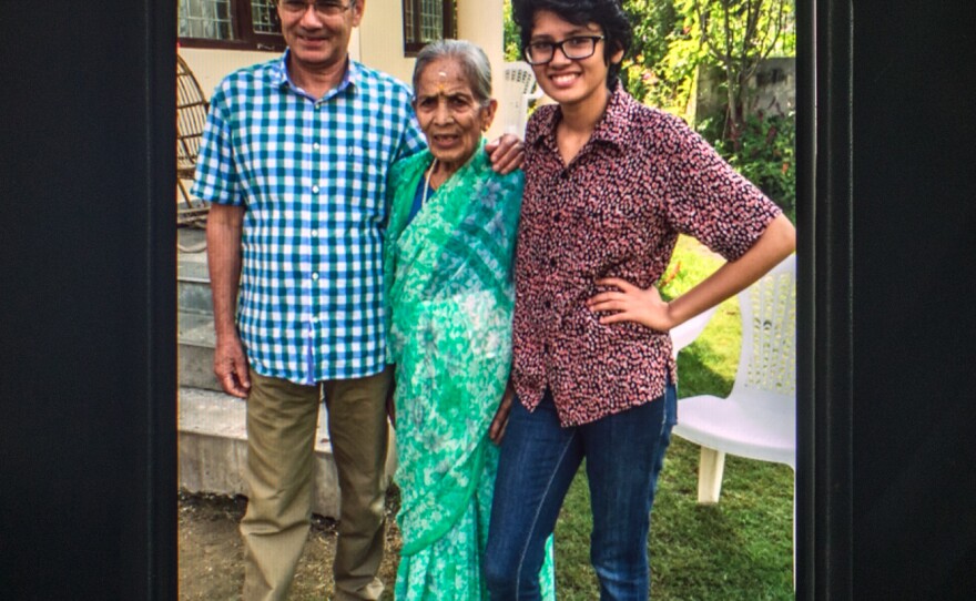 In this family photo, Prakriti Kandel poses with her grandmother and father in their garden.