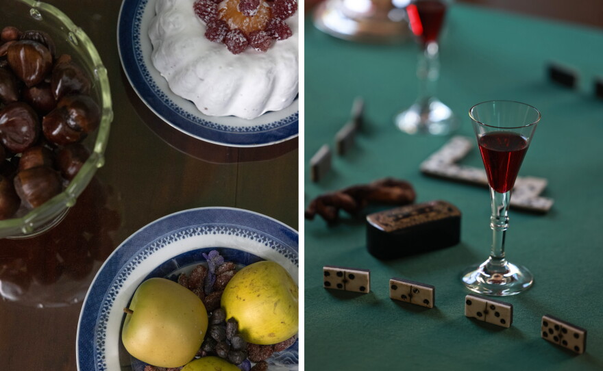 Tables are set up with displays of upper-class dining at the William Paca House in Annapolis. Left: A table is set with fruit, nuts and cake. Right: Another table is set with dominoes and replica glasses of punch.