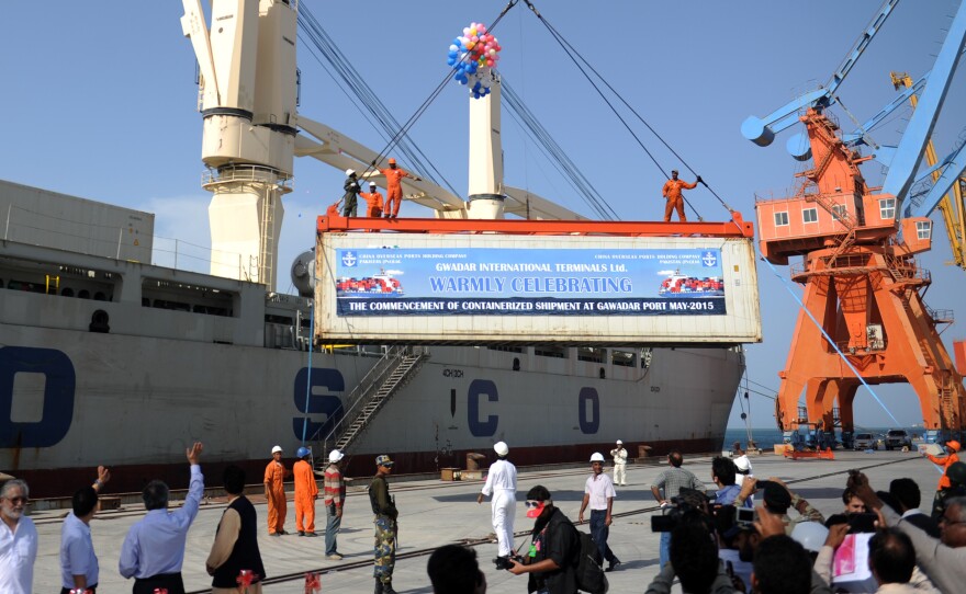 A container is loaded onto a ship during the inauguration of container service in Gwadar on May 11. China and Pakistan have agreed to build an economic corridor that will run from the Pakistani port to western China.