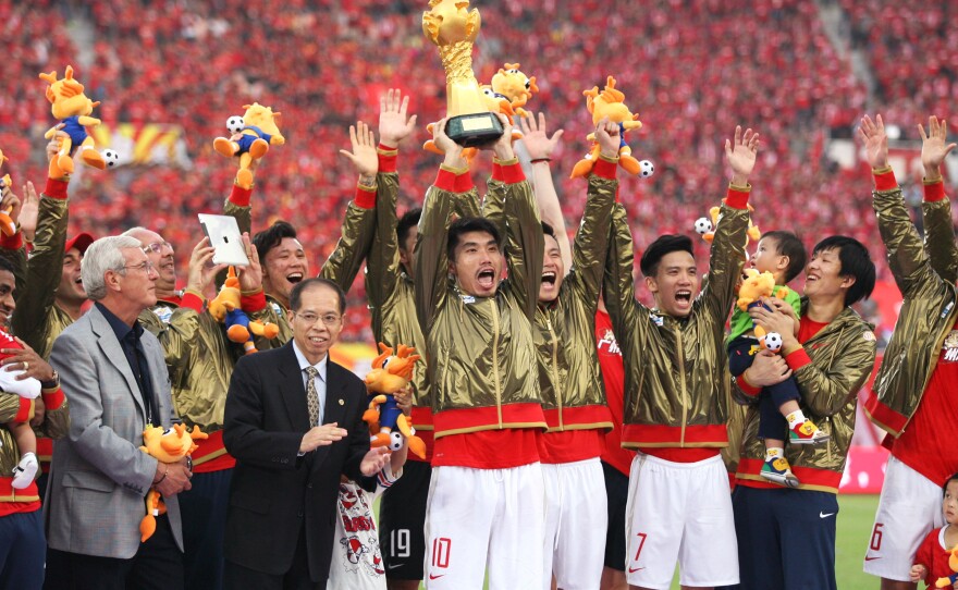 Guangzhou Evergrande players celebrate after winning the 2013 Chinese Super League title. The club has won the last five titles.