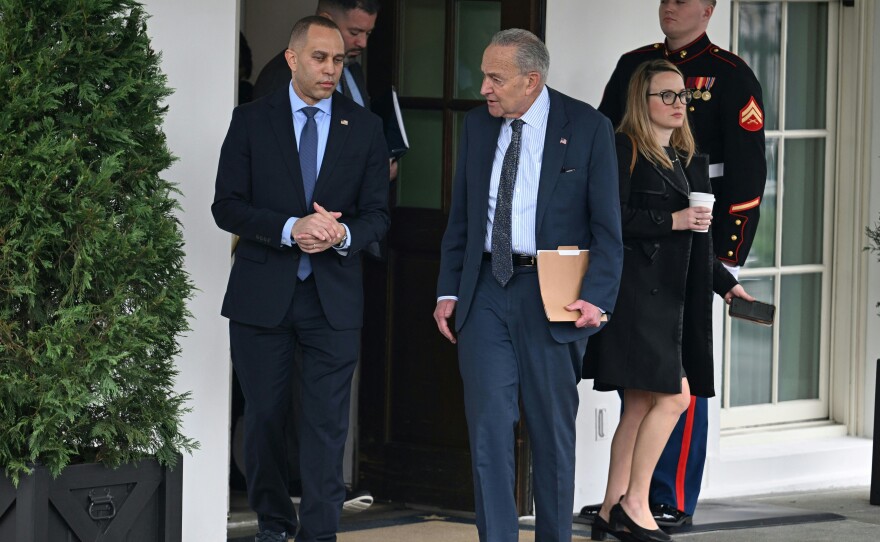 House Minority Leader Hakeem Jeffries and Senate Majority Leader Chuck Schumer leave the West Wing to speak with reporters after a meeting with President Biden and Republican congressional leaders.