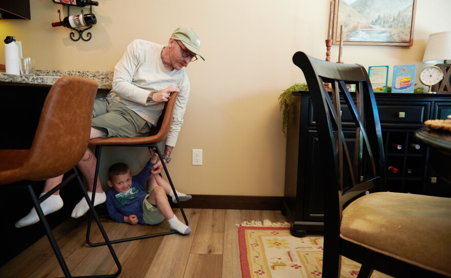Neil Petersen plays with his 4-year-old son, Jack. Neil works in a factory painting boom trucks.