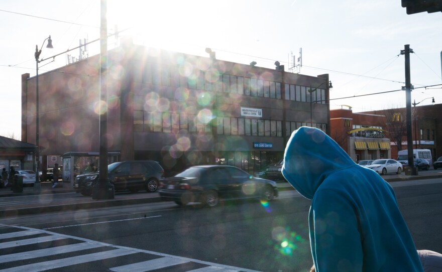 A man walks on Benning Road in Northeast Washington, D.C., in front of the Greater Northeast Medical Center, where Dr. Edwin Chapman works.
