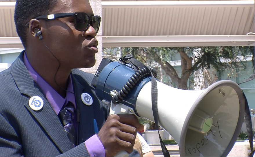 Mohamed Mohamed, a senior at San Diego High School, protests poor interpretation services at UCSD Medical Center, July 9, 2013. He says he's missed several days of class — even his high school exit exam — because he has to interpret for his dad at doctors' appointments.