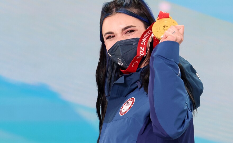 Gold medalist Brenna Huckaby of Team USA celebrates on the podium during the medal ceremony for the women's banked slalom SB-LL2.