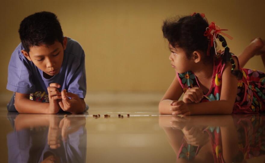 Adi’s children play with jumping beans.