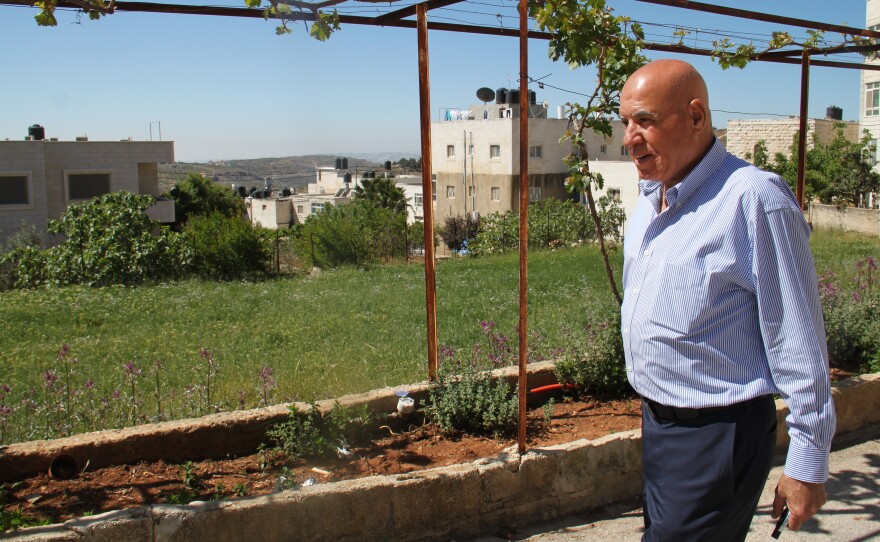 Omar Omar outside his family's home in the village of Deir Jarir. After living in the U.S. for decades, he sees the West Bank with the eyes of an outsider.