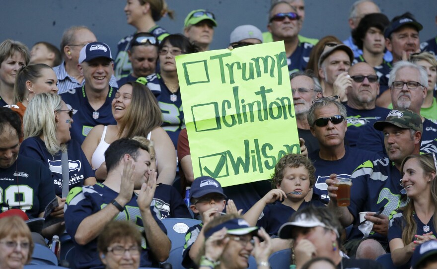 A Seattle Seahawks fan holds a sign suggesting quarterback Russell Wilson for president instead of Hillary Clinton or Donald Trump.