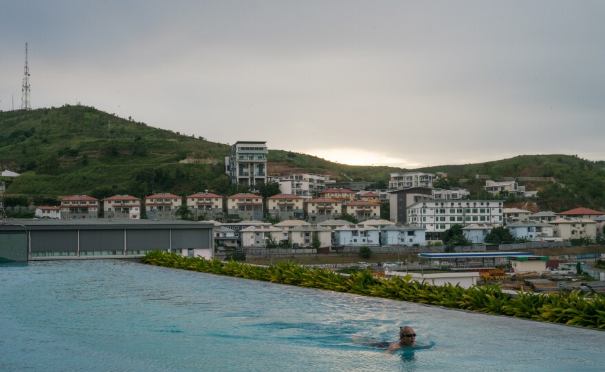 A woman swims in the pool at the Stanley Hotel And Suites, a luxury hotel in Port Moresby's upscale Waigani neighborhood, where many government buildings and a mega-mall are located.