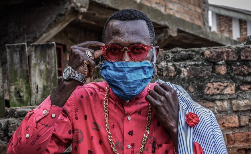 Anglebert Maurice Kakuja, 29, a Sapeur, or Congolese dandy, shows off his fashion sense while wearing a homemade mask in the eastern Congolese city of Bukavu. Sapeurs take their name from the acronym for their group: Societe des Ambianceurs et des Personnes Elegantes.