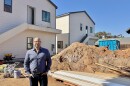 Daniel Shkolnik stands in front of a 12-unit ADU project his company is building in San Diego's Palm City neighborhood, Feb. 26, 2025.