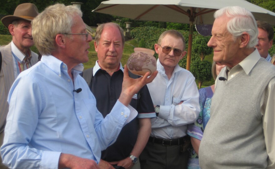 Andy McConnell examines a Galle glass bowl found in a junk shop.