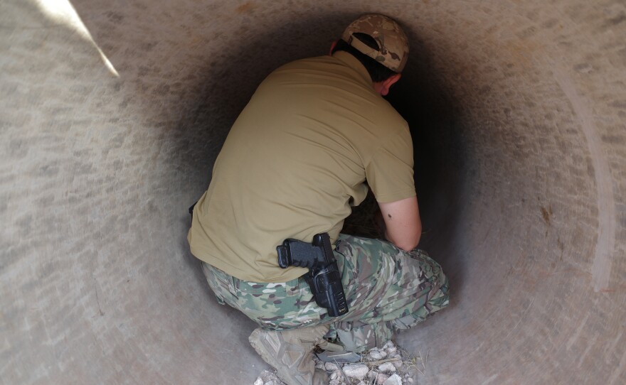 Hobayd, a senior commander of the Uyghur militants in Syria, crouches in a strategic tunnel used during the 2024 offensive against then-President Bashar al-Assad's regime.
