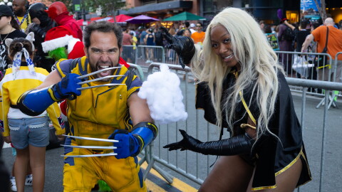 Wolverine and Storm cosplayers pose in character at Comic-Con on July 24, 2026.