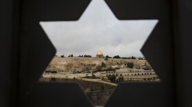 Jerusalem Old City is seen trough a door with the shape of star of David, in Jerusalem, Wednesday, Dec. 6, 2017.