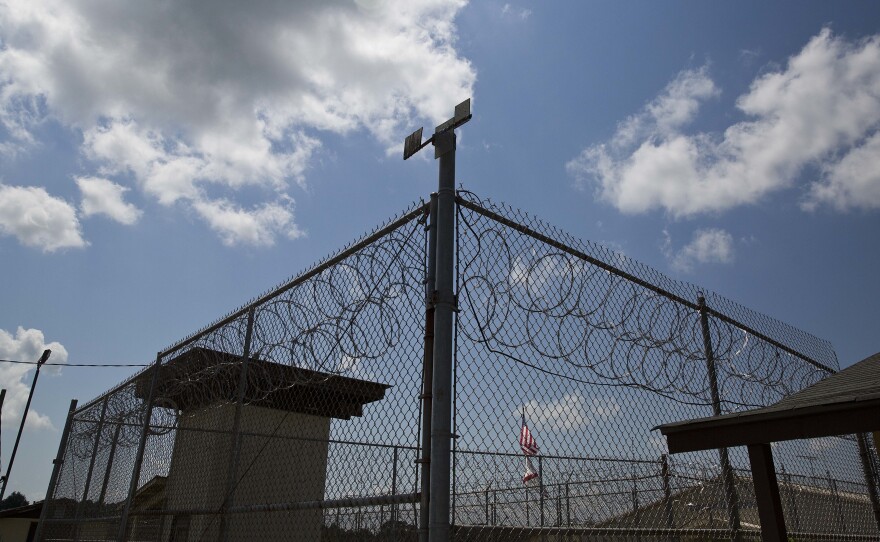 A fence stands at Elmore Correctional Facility in Elmore, Ala., seen in 2015. A federal judge ruled that mental health care for inmates is "horrendously inadequate."