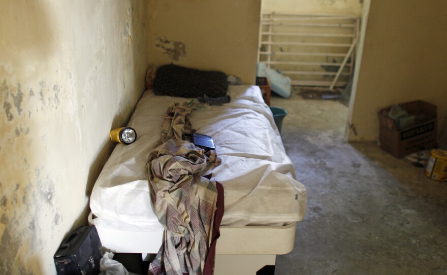 A bed is seen inside an abandoned house, which has no running water or electricity, now occupied by Rivera's family.