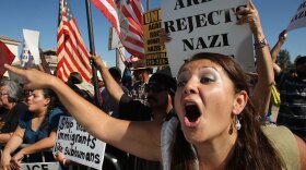 Erika Paz yells at members of the white supremacist group, the National Socialist Movement, during the group's anti-illegal immigration rally last month.