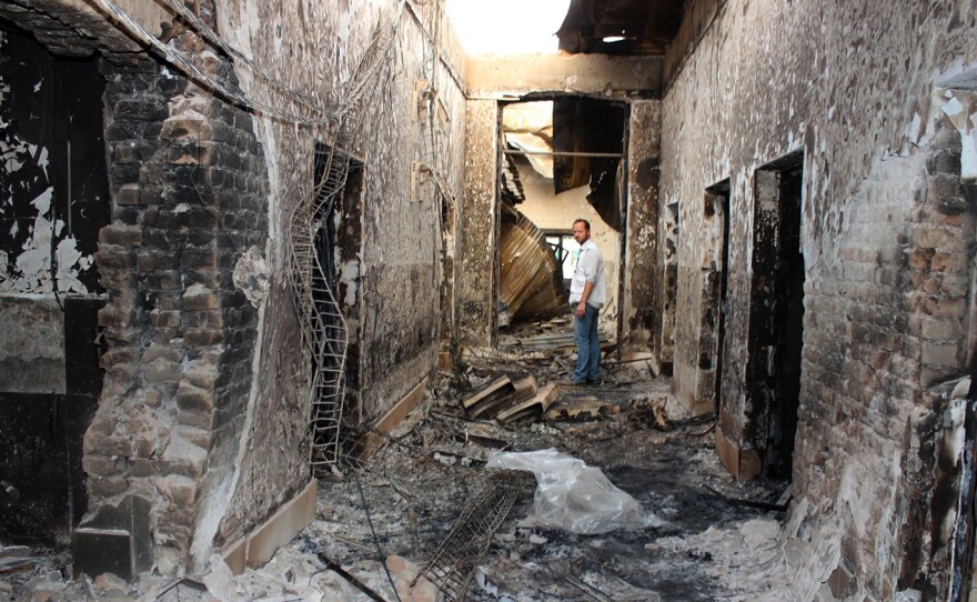 On Oct. 16, 2015, an employee of Doctors Without Borders stands inside the charred remains of the organization's Kunduz hospital following a U.S. airstrike.