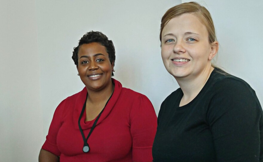 Sharita Moultrie, left, a navigator with the Palmetto Project, helps Stephanie Hickman enroll in an Obamacare plan in Columbia, S.C.