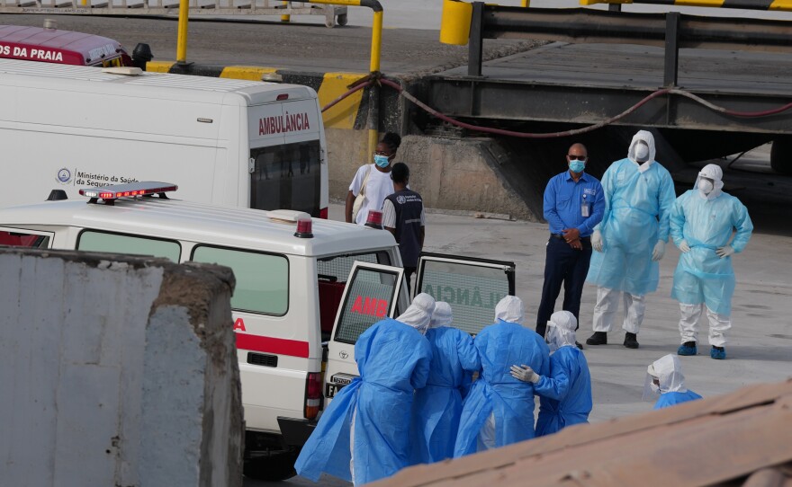 Health workers in protective gear evacuate patients from the MV Hondius cruise ship into an ambulance at a port in Praia, Cape Verde, Wednesday.