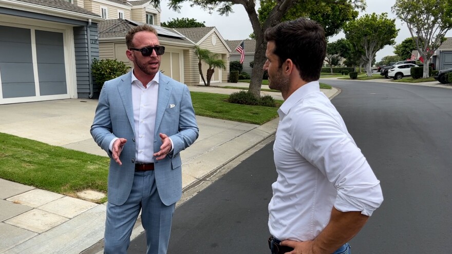 Attorney Nicholas Caplin (left), standing outside his client's house, speaks with KPBS reporter Scott Rodd about pickleball noise disputes, Aug. 17, 2023..