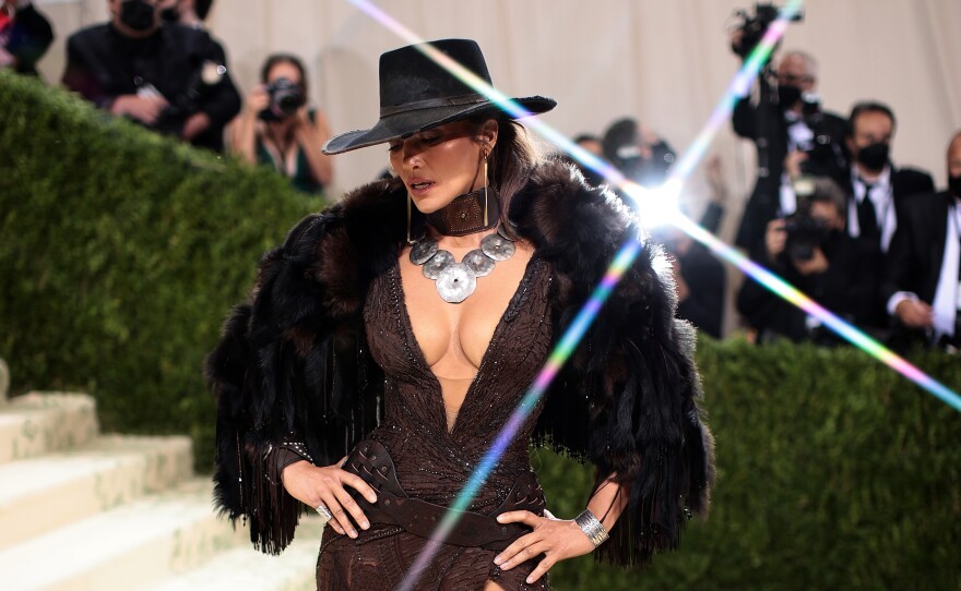 Jennifer Lopez wears a David Koma dress with a cowboy hat.