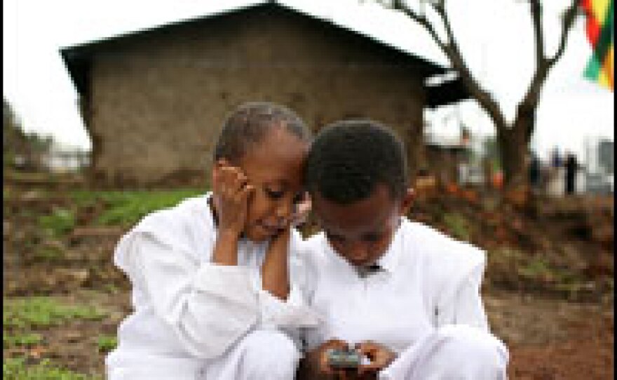 Children in in Debre Zeit, Ethiopia play with a phone in 2008.
