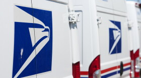 Delivery vans are parked outside the main United States Postal Service headquarters in northeast Denver on July 28.