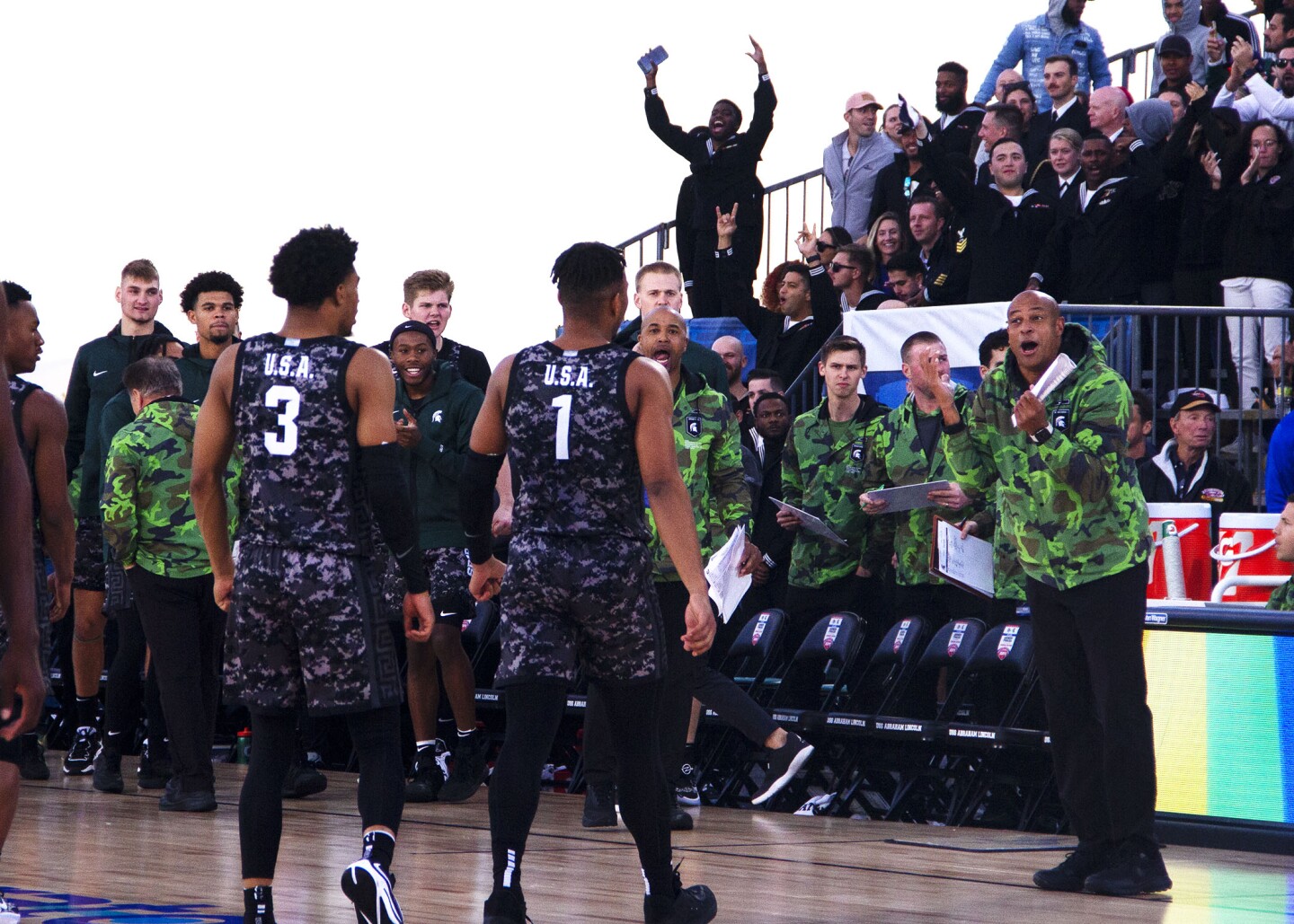 MSU coaching staff speak with players during the Armed Forces Classic aboard USS Abraham Lincoln in San Diego on Nov. 11, 2022.