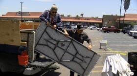 Berta and Santiago Soto of Santiago's Farm are setting up their produce stand at the new farmer's market in Linda Vista. 