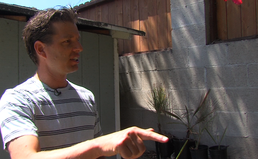 Matt Spydell stands by his backyard composting bin, April 4, 2016.