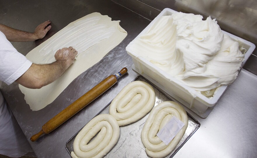 A baker prepares ensaïmades, a traditional sweet bread, at a bakery in Palma de Mallorca. The ensaïmada is a traditional Mallorcan dessert made with reduced pork lard.