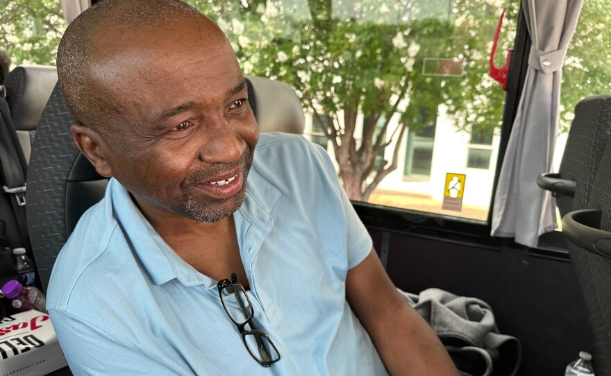 Keith Odom, a forklift driver from Aiken, S.C., looks out from his bus seat as he arrives in Montgomery, Ala., for a voting rights rally Saturday, May 16, 2026.