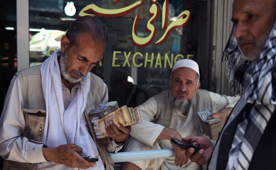 Afghanistan's currency has fallen by 12 percent against the U.S. dollar in the past year. Some Afghan money changers now prefer to covert their earnings to dollars.