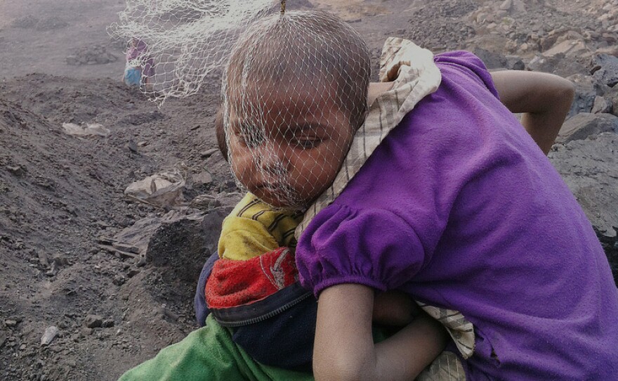 Children wait for their parents — coal pickers at a mine in Jharia — to return from work.