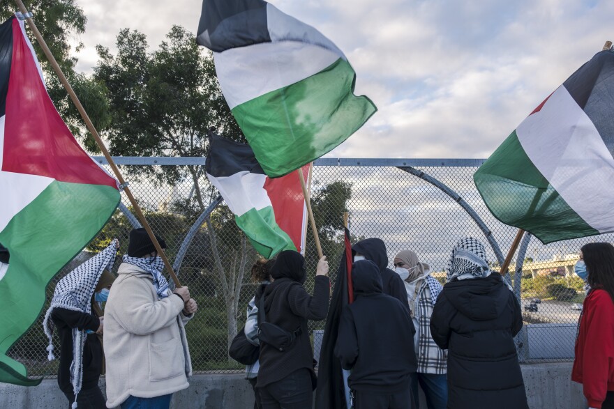 During the morning commute around two dozen proponents of a ceasefire in Gaza hung banners from a bridge overlooking northbound Interstate 5 at Nobel Drive in San Diego, Jan. 10, 2024.