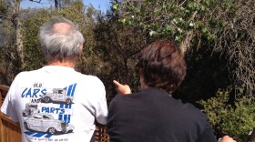 Robert and Lynn Dillon watch nervously as a wildfire burns near their home on Willowgrove Avenue in Santee.