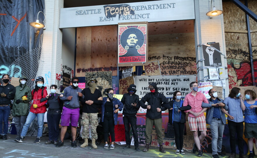 CHOP demonstrators, fearing the police returning to take back the East Precinct of the Seattle Police Department, stage a drill outside the building on June 22, 2020.