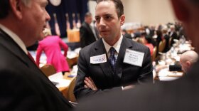 Reince Priebus talks with members during the Republican National Committee meeting on Friday in Oxon Hill, Md. Priebus was selected as RNC chairman after seven rounds of voting.