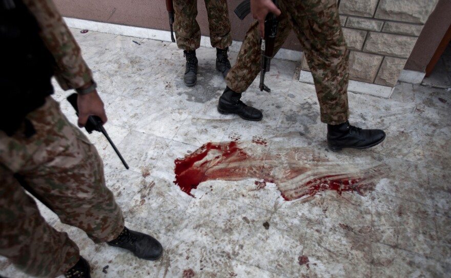 Pakistan army soldiers stand outside the auditorium of an Army Public School a day after an attack on the school, in Peshawar, Pakistan, on Wednesday.