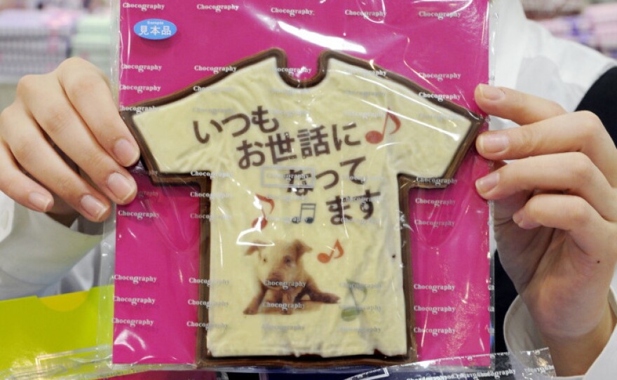 An employee at Tokyo store Message de Rose displays Valentine's Day chocolates at the Takashimaya department store's "Amour du Chocolat" event.