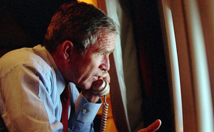 President Bush speaks to Vice President Dick Cheney by phone aboard Air Force One after departing Offutt Air Force Base in Nebraska, on Tuesday, Sept. 11, 2001.